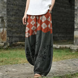 Florence – Wijde broek met oranje bloemenpatroon