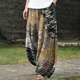 Coralie – Brede gouden broek met crane- en wolkenpatroon