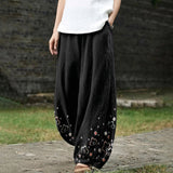 Armelle – Brede zwarte broek met bloemenpatroon