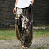 Delphine – Brede witte broek met bloemenpatroon
